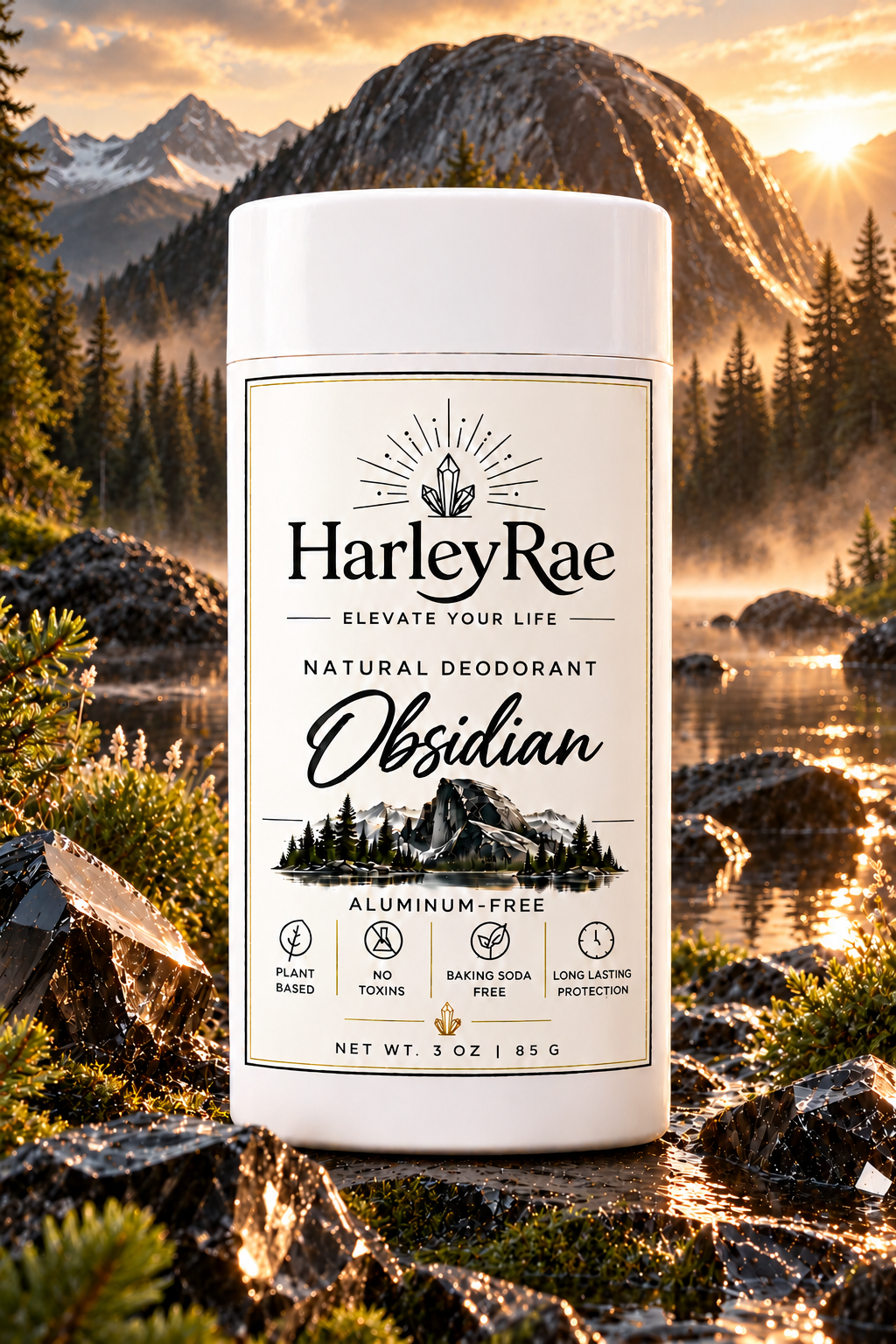 A white cylindrical deodorant stick labeled HarleyRae Obsidian stands in front of a scenic mountain-and-lake landscape at sunset. The label includes text such as 'Natural Deodorant,' 'Obsidian,' 'Aluminum-Free,' and feature icons.