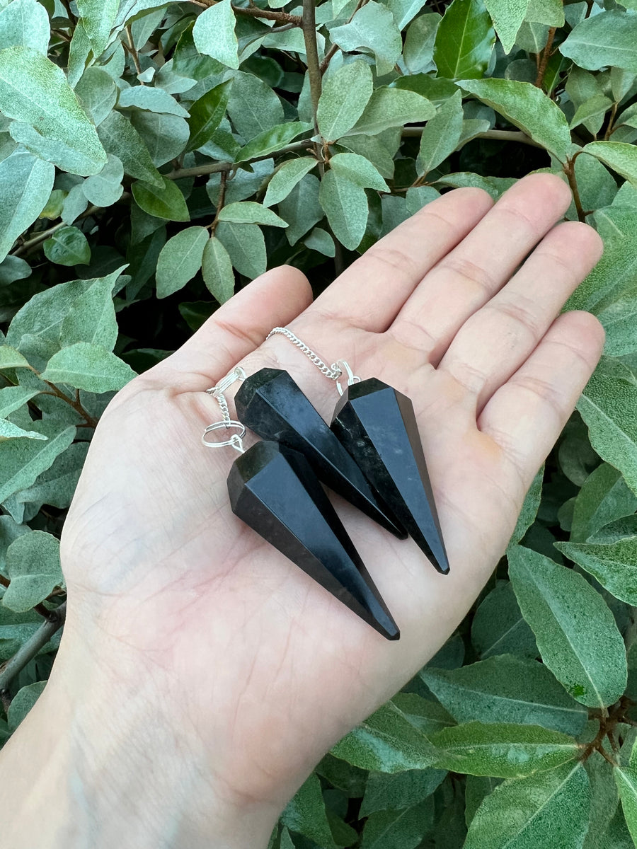 HarleyRae holding two black Tourmaline pendulums 