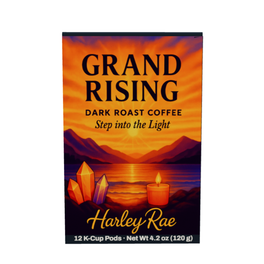 A box of Harley Rae Grand Rising dark roast coffee pods, featuring a sunset landscape with mountains, a lake, crystals, and a candle on the front.